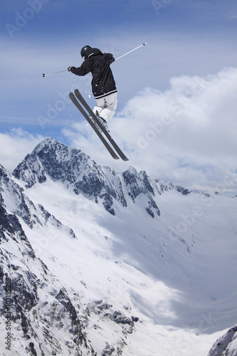 Flying skier on mountains. Extreme sport.