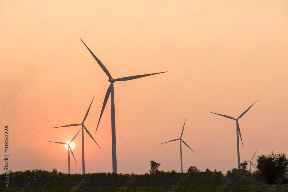 silhouette of wind turbines at sunset silhouette of wind turbines at sunset