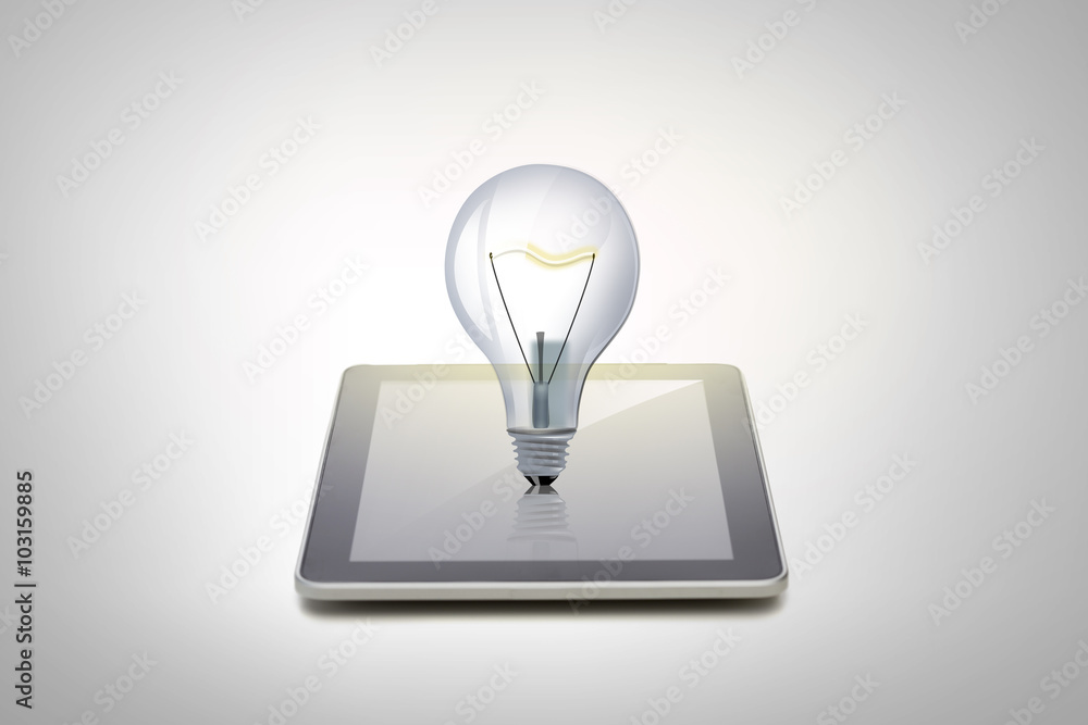 close up of tablet pc computer with light bulb close up of tablet pc computer with light bulb