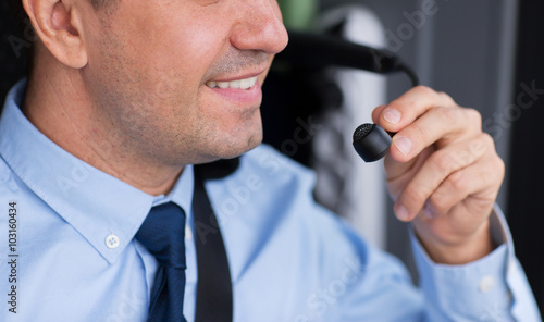 close up of happy bus driver talking to microphone