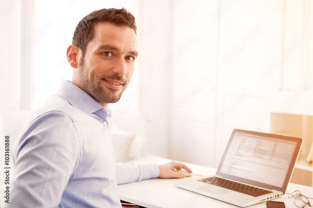 Young business man working at home on his laptop Young business man working at home on his laptop