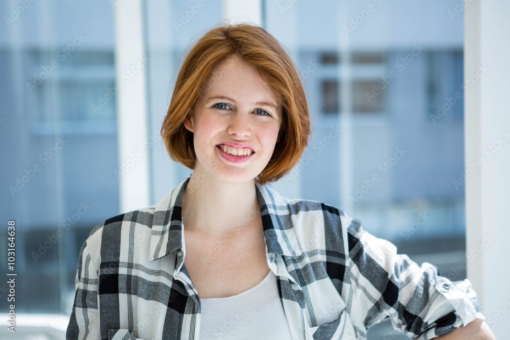 Red haired hipster smiling at camera