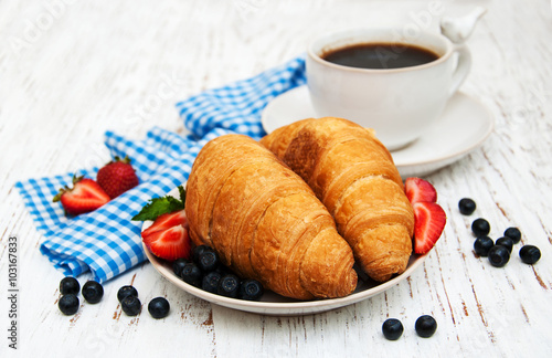 Fresh berries  coffee and croissant