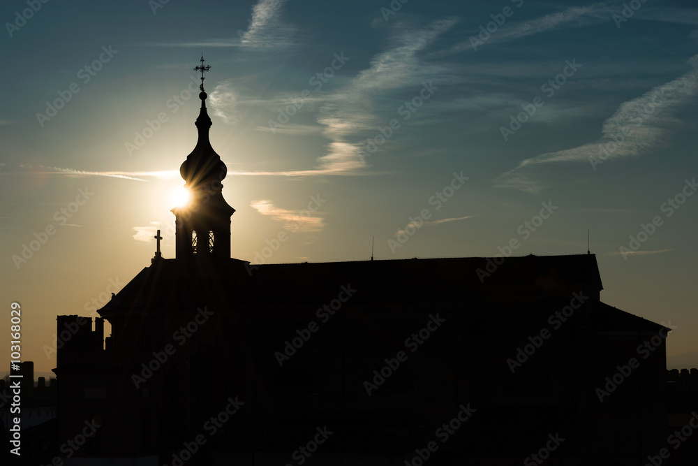Church tower in evening light with aperture star - symbol of ecumenism