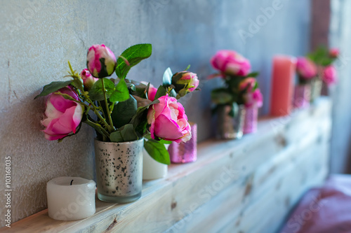 flowers in a vase on a shelf