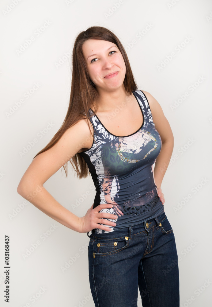 beautiful slim girl in denim pants and red high-heeled shoes and t-shirt without sleeves beautiful slim girl in denim pants and red high-heeled shoes and t-shirt without sleeves