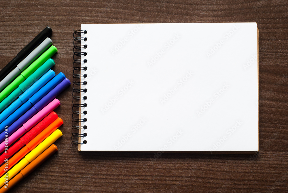A set of markers and sketch pad A set of markers and sketch pad