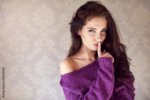 mysterious sexy woman. Natural beauty. A woman in purple sweater