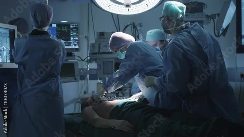 Medical Team Performing Defibrillation in Modern Operating Room. Shot on RED Cinema Camera.