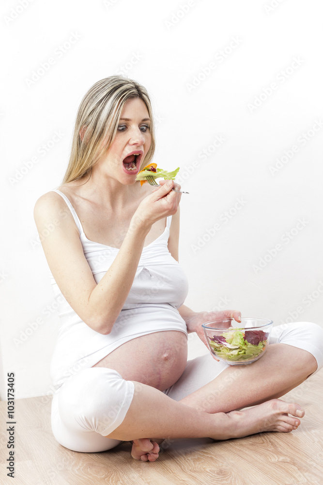 pregnant woman eating vegetable salad pregnant woman eating vegetable salad