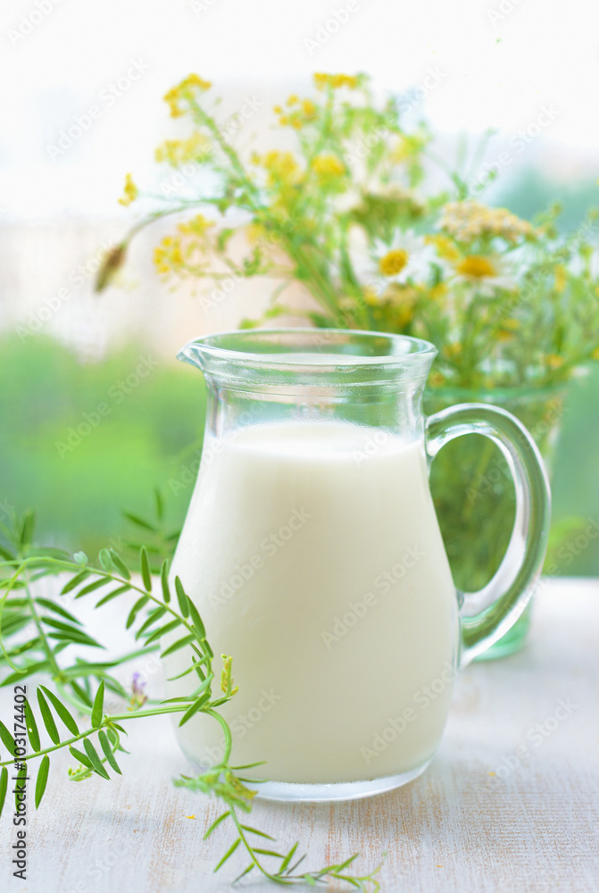 Jug of milk and bouquet wild flowers Jug of milk and bouquet wild flowers