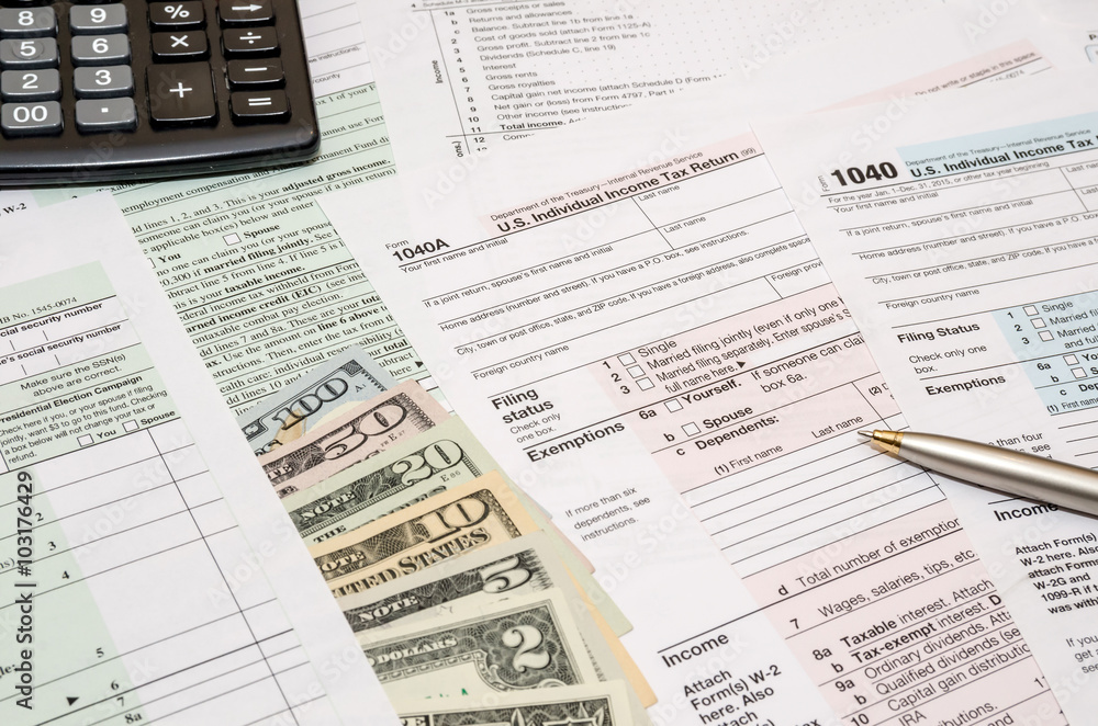 1040 tax form with pen, dollar and calculator 1040 tax form with pen, dollar and calculator