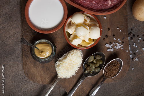 Set of ingredients for cooking on old wooden background