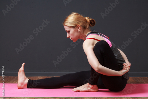 Yoga. Pilates. Stretching. Young blonde woman doing yoga exercise photo