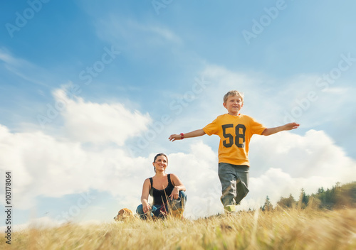 Boy running on golden field