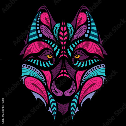 Patterned colored head of the wolf. African / indian / totem / tattoo design. It may be used for design of a t-shirt, bag, postcard and poster.