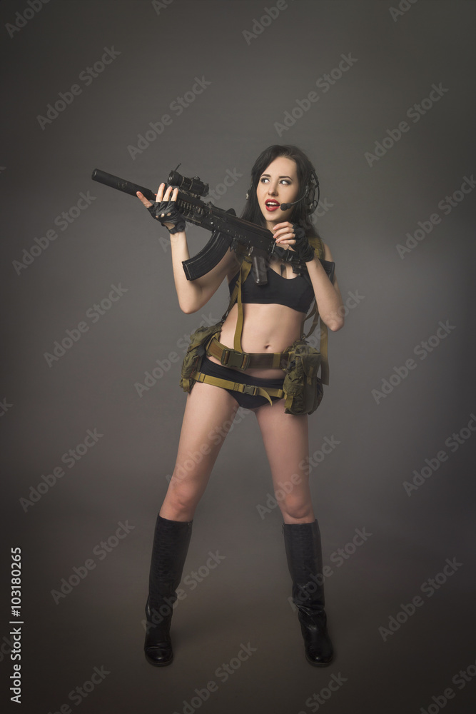 Young brunette in camouflage with a gun Young brunette in camouflage with a gun