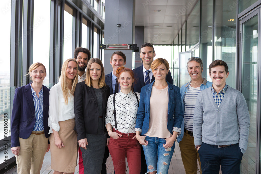 Group shot of business people in modern office hall.