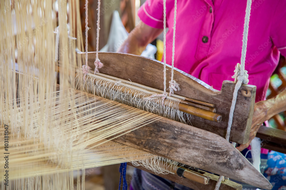 Silk weaving on loom.