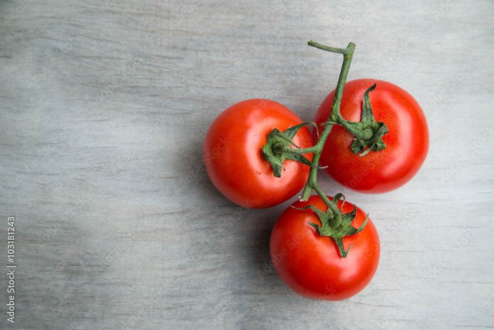 fresh red delicious cherry tomatoes on an old wooden tabletop fresh red delicious cherry tomatoes on an old wooden tabletop