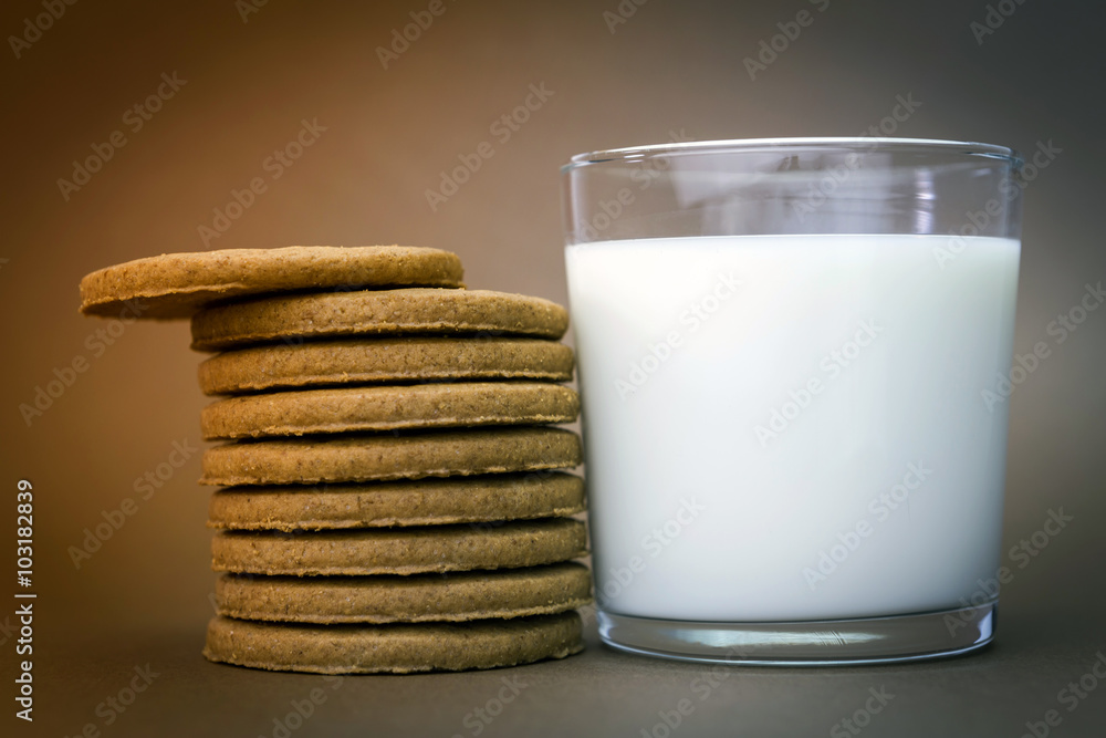 Glass of milk and biscuits round