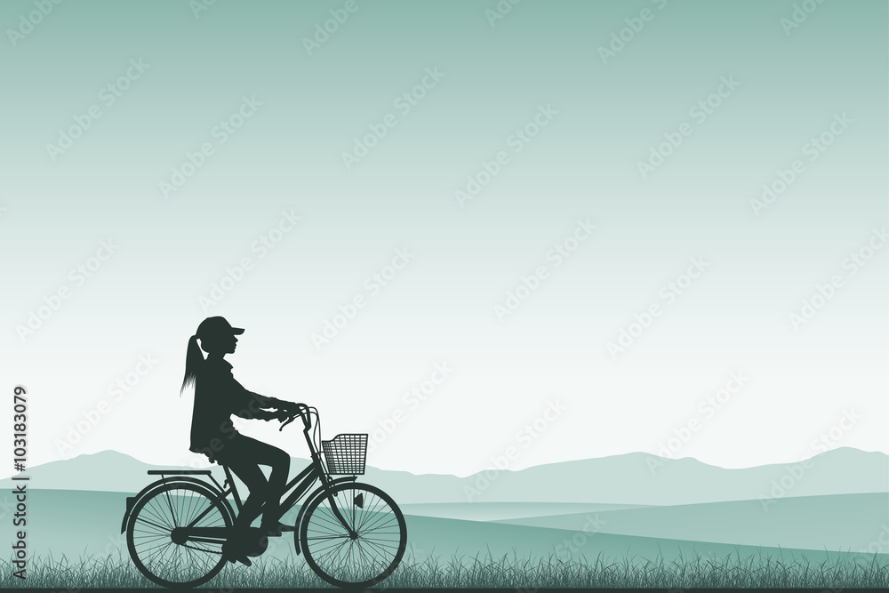 Obraz premium A Girl on a Bicycle in Silhouette with Meadow Landscape