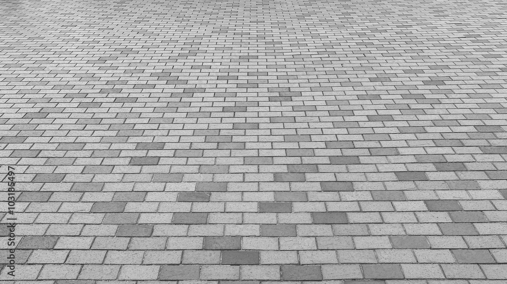 Naklejka premium Perspektywiczny widok Monotone Grey Brick Stone Street Road. Chodniczek, Bruk Tekstury Tło