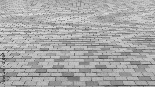 Perspective View of Monotone Gray Brick Stone Street Road. Sidewalk, Pavement Texture Background