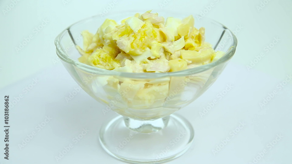 Salad of eggs, orange, chicken, cheese, standing in a dish on the table Salad of eggs, orange, chicken, cheese, standing in a dish on the table