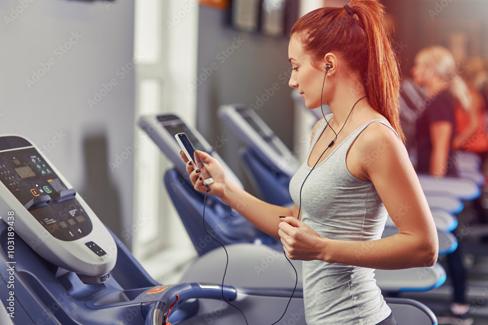 woman runing on a treadmill woman runing on a treadmill