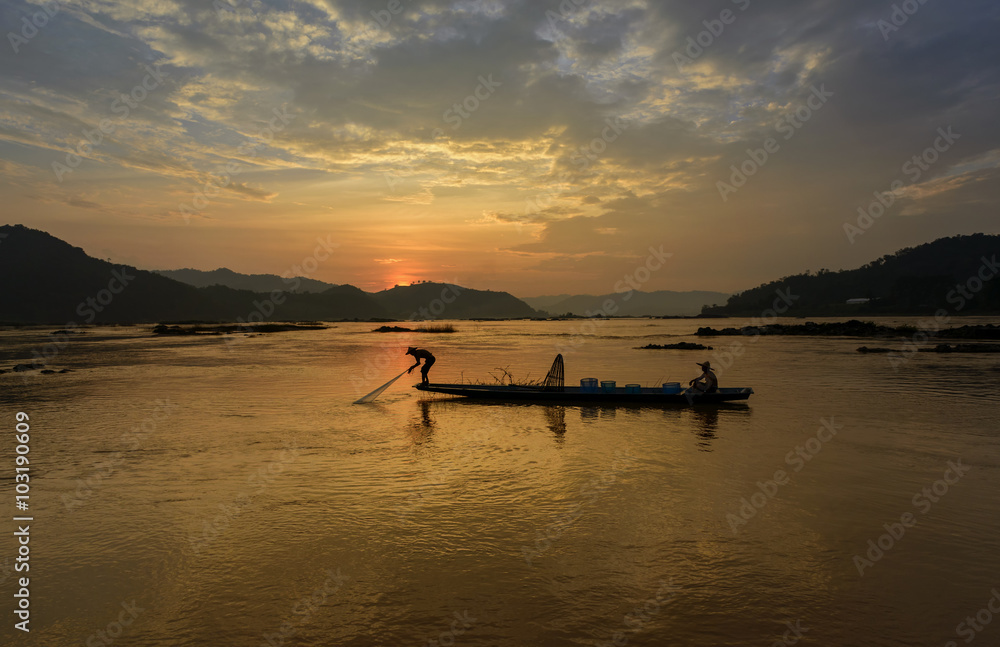 fisherman throwing nets during on sunset in Meakhong river Thai-Loas