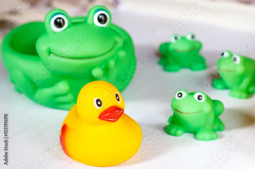 Child bath toys on a white wooden surface