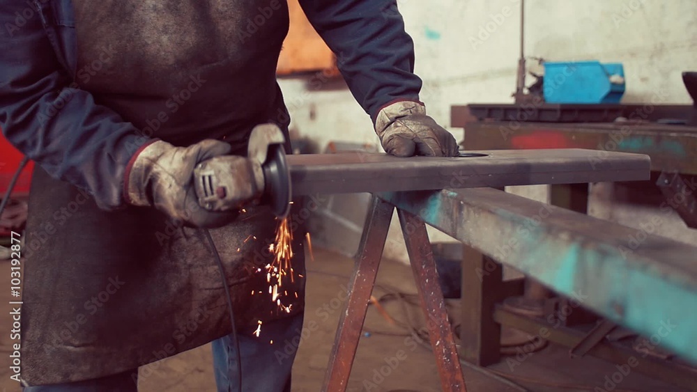 Slow motion shot of Metal worker grinding in factory
Slow motion shot of Metal worker grinding in factory