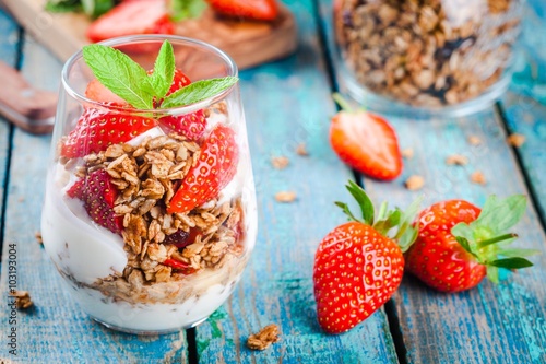 Homemade granola parfait with strawberry and mint.
