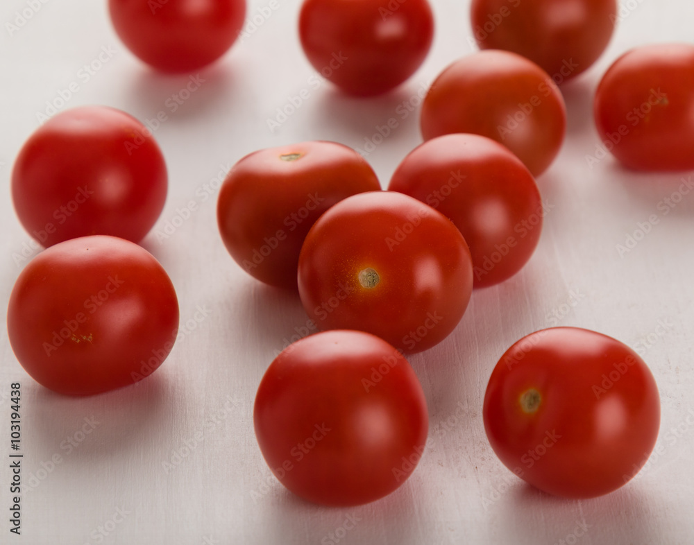 cherry tomatoes on white table cherry tomatoes on white table