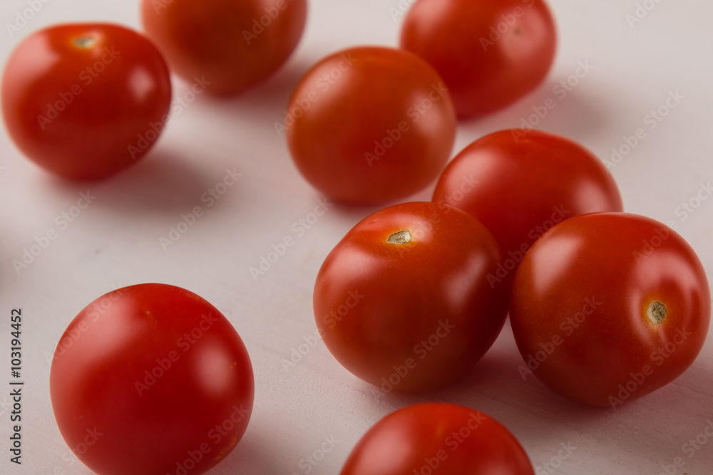 cherry tomatoes on white table cherry tomatoes on white table