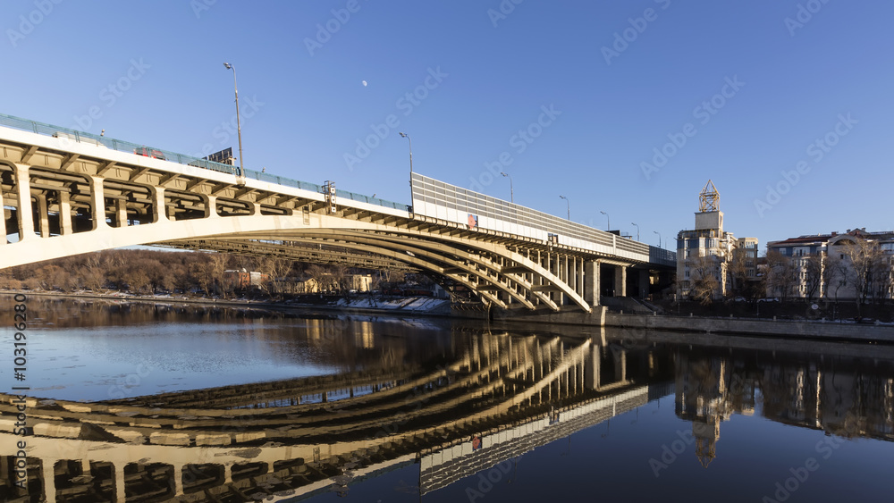 Naklejka premium Details of steel bridge and reflection in water of moscow river