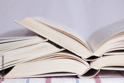 Pile of the opened books on a table