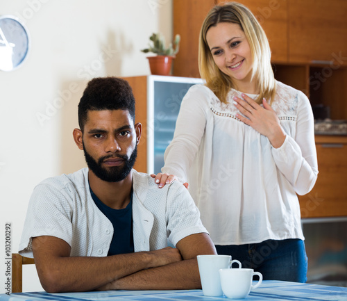 White girl and afro guy trying make out after argue photo