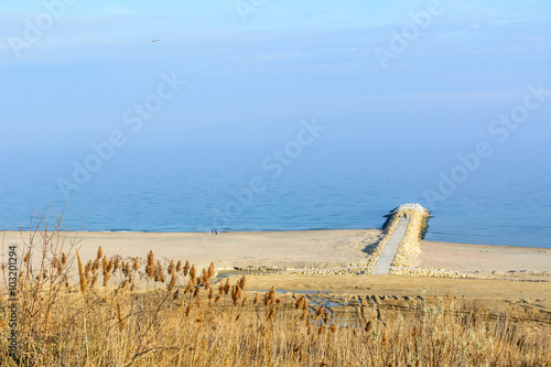 Panoramic view with seashore, sand, waterand blue sky. Sea water