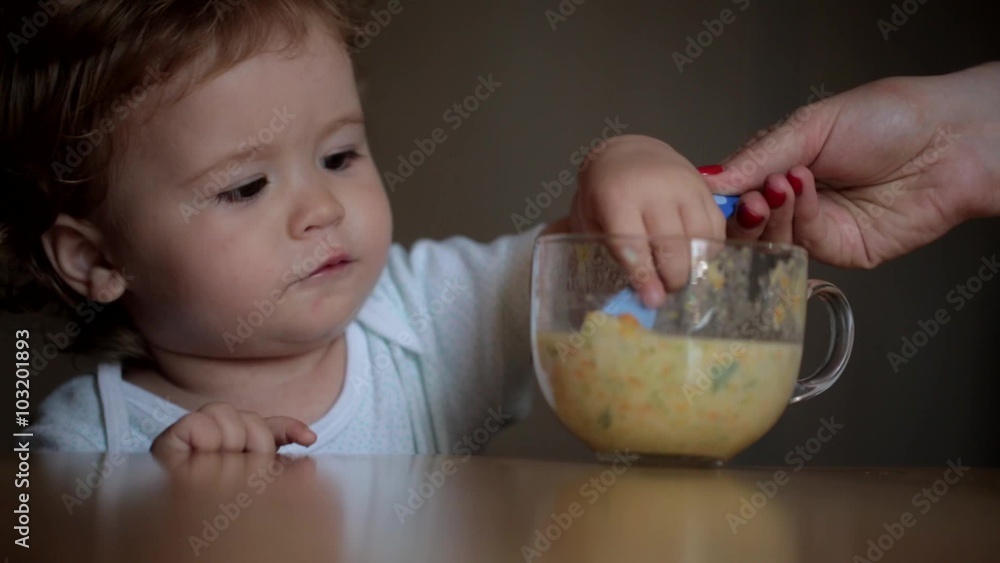 Mother teaches the baby to eat vegetables Mother teaches the baby to eat vegetables
