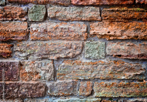 Old brick wall. Apply color and lighting effects. Colorful picture. Deep, rich, bright colors. Vignetting. Art reception.