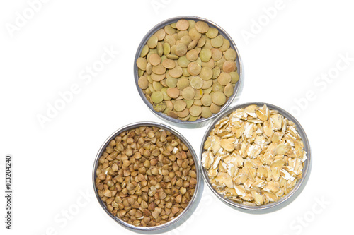 Cereals on a white background: lentils, buckwheat, oatmeal