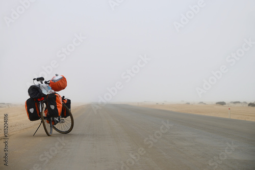 Long distance cycling in the misty Namib, Namibia