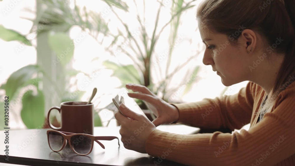 Always online. Tourist woman using her tablet at coffee shop. Always online. Tourist woman using her tablet at coffee shop.
