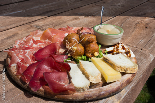 Valtellina - Typical culinary delights served at the alpine huts. The platter after trekking: speck,cheese,sciatt (buckwheat cheese fritters),ham, onion. Italy

 photo