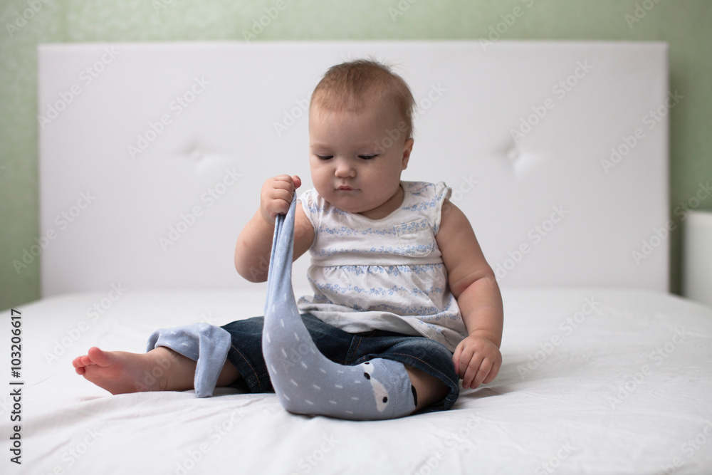 Toddler baby pulls socks, independence, childhood, home, light