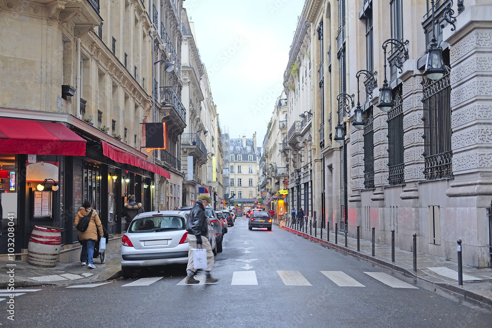Paris, France, February 12, 2016: pedestrian cross road in a center of Paris, France