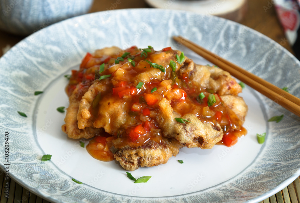 Sweet and sour pork and rice on plate with chopsticks, Chenese cuisine Sweet and sour pork and rice on plate with chopsticks, Chenese cuisine