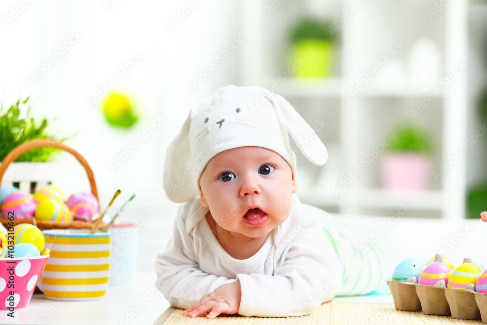 happy baby child with Easter bunny ears and eggs and flowers happy baby child with Easter bunny ears and eggs and flowers